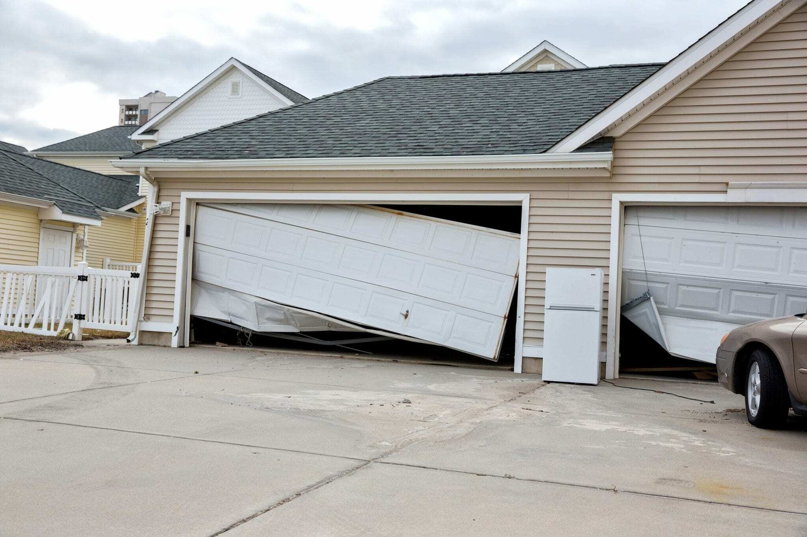 An old, damaged garage door ready to be replaced with a new IronLift door